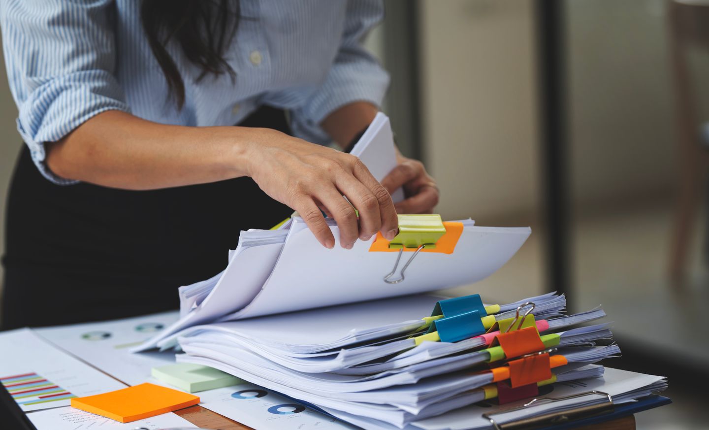 A person is sorting documents